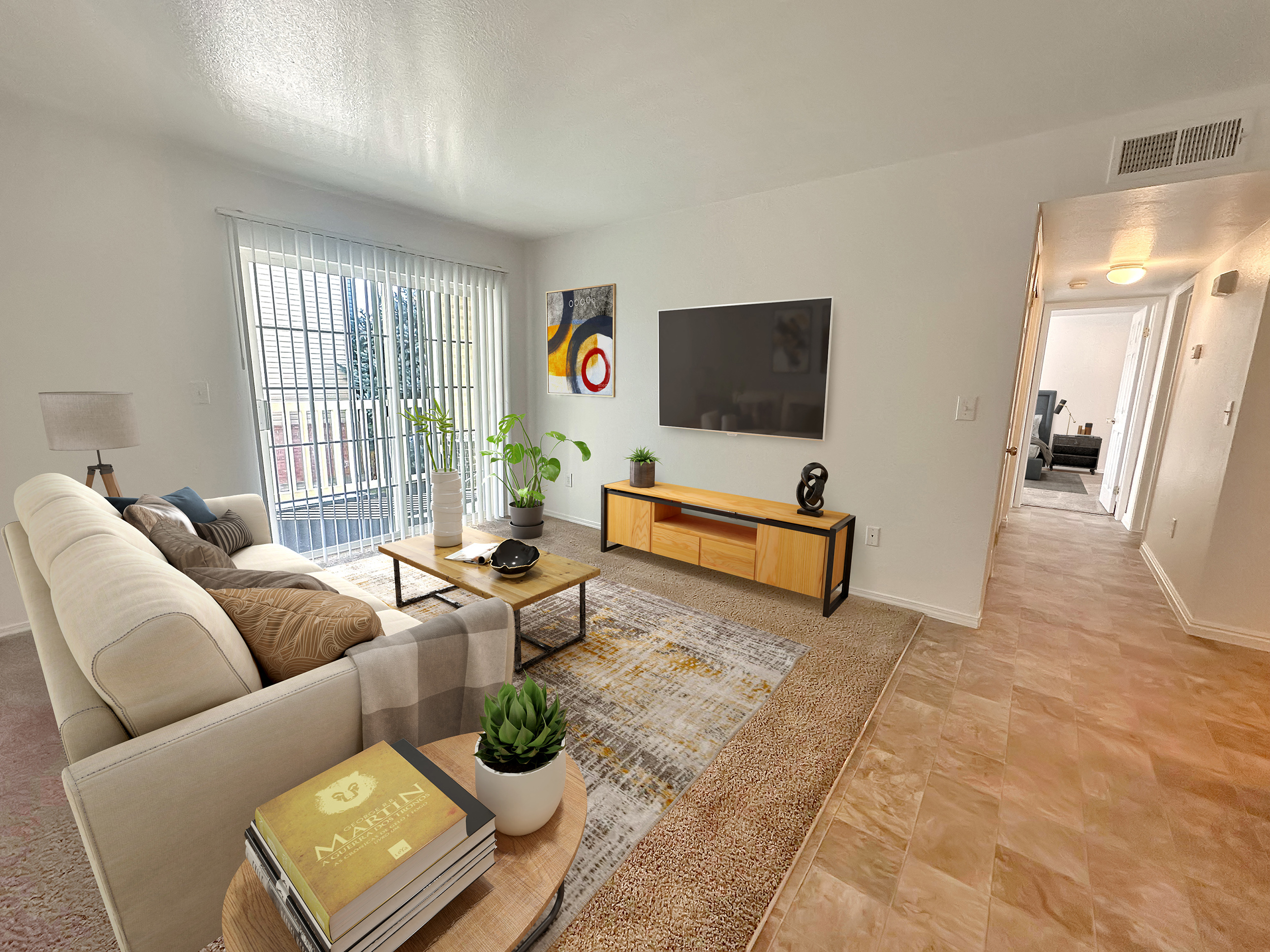 the living room of an apartment with a couch and a tv